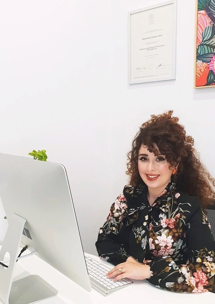 Ramsina seated at the Hope Nutrition clinic desk